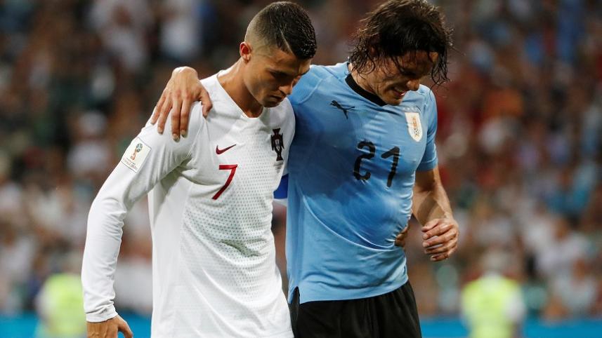 Cristiano Ronaldo helps Uruguay's Edinson Cavani