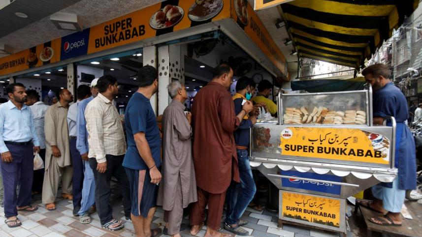 অর্থনৈতিক সংকটে আক্রান্ত পাকিস্তানের বাসিন্দারা স্বস্তা খাবার কেনার জন্য সারিবদ্ধ হয়ে দাঁড়িয়ে আছেন। ছবি: রয়টার্স