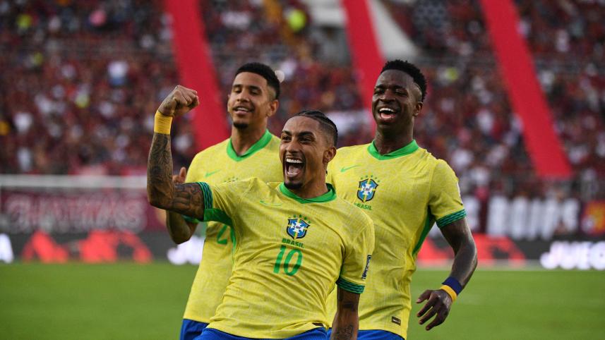 Brazil's forward #10 Raphinha celebrates with teammates forward #20 Savinho (L) and forward #07 Vinicius Jr (R)