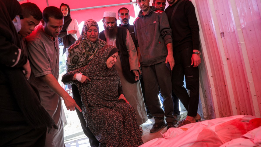 গাজায় নিহত ফিলিস্তিনির মরদেহকে ঘিরে স্বজনদের আহাজারি। ছবি: এএফপি