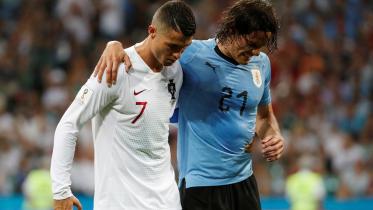 Cristiano Ronaldo helps Uruguay's Edinson Cavani