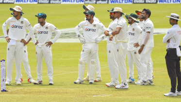 Bangladesh's cricketers look at the third umpire's dismissal of  Sri Lanka's Dimuth Karunaratne.jpg