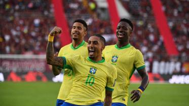 Brazil's forward #10 Raphinha celebrates with teammates forward #20 Savinho (L) and forward #07 Vinicius Jr (R)