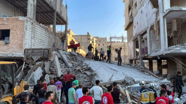 সিরিয়ায় ফেলে রাখা বোমা বিস্ফোরণে চার তলা ভবন ধ্বংস হয়েছে। ছবি: এএফপি