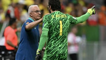 Brazil's head coach Dorival Junior speaks with Brazil's goalkeeper Alisson 