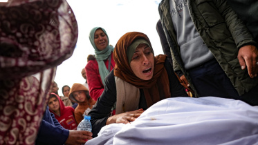 উত্তর গাজায় ইসরায়েলি বিমান হামলায় নিহত আত্মীয়র মরদেহের সামনে মাতম করছেন ফিলিস্তিনিরা। ছবি: এএফপি