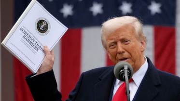 শুল্ক ঘোষণার সময় এই নথি উঁচিয়ে ধরেন ট্রাম্প। ছবি: রয়টার্স